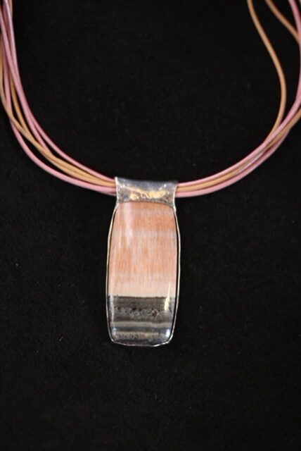 11. One of a kind sterling silver backed cabochon of celestobarite on small leather choker. 2022    1 7/8”  h  x  ¾”  w --   $2,500